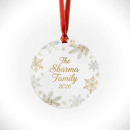 Round clear acrylic Christmas ornament with personalized family name The Sharma Family 2026 surrounded by snowflakes and pine branches on white background
