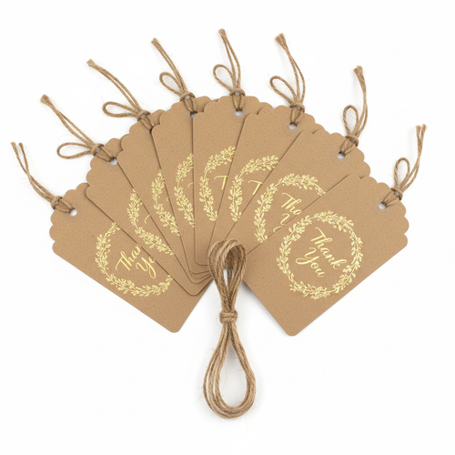Set of 10 kraft paper gift tags with gold foil floral wreath and Thank You text tied with twine on white background